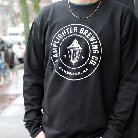 Black crewneck sweatshirt with circle Lamplighter logo